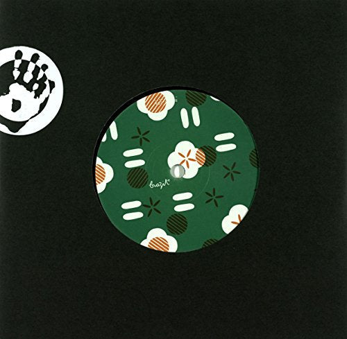 Green vinyl record with fried egg and floral pattern design.