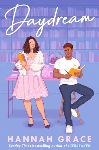 A woman in a pink dress and a man in jeans sit in a library.