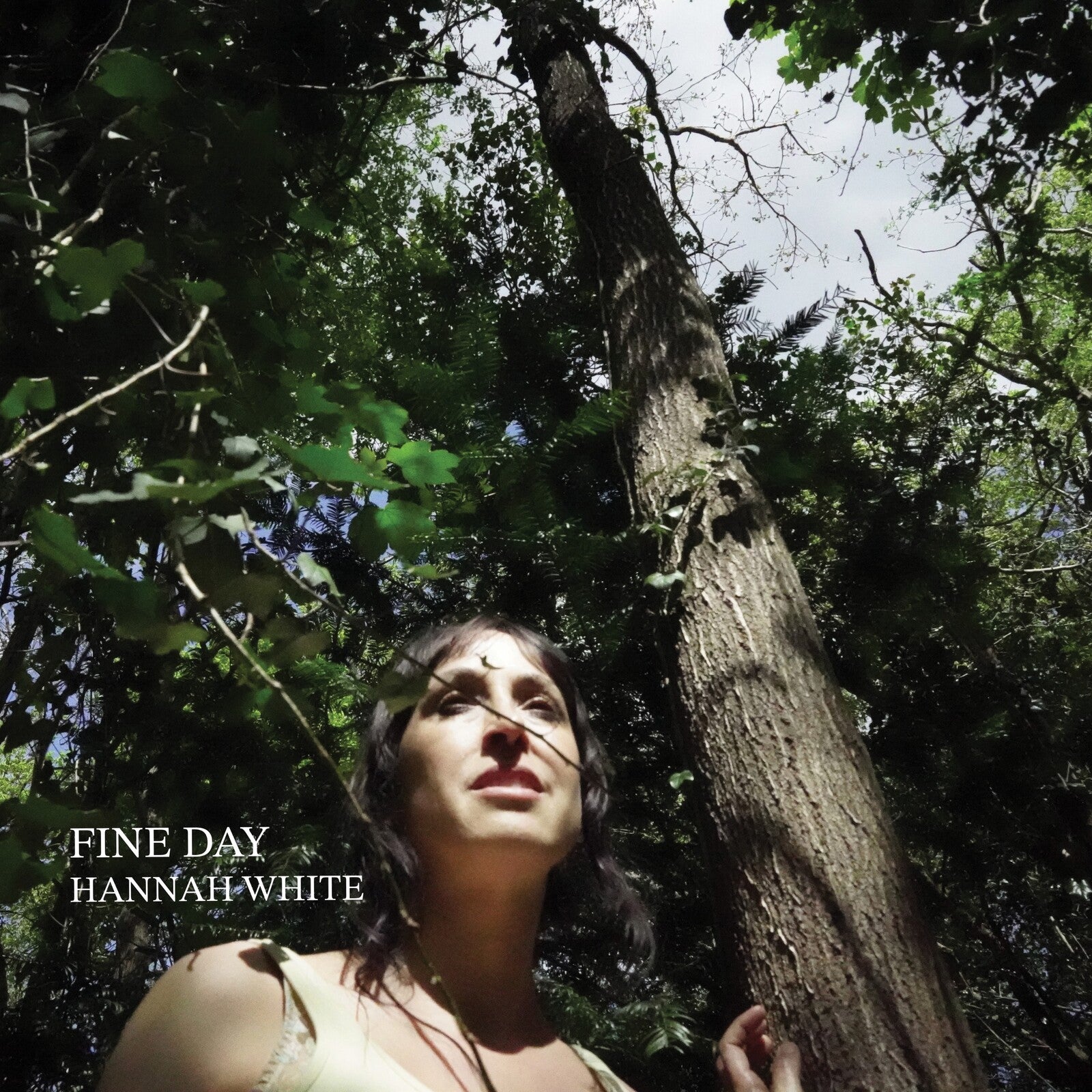 Album cover: woman looking up at trees, text "Fine Day" and artist name.