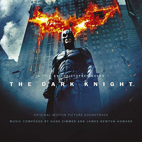 "CD cover featuring Batman standing before a burning building, with 'The Dark Knight' title."