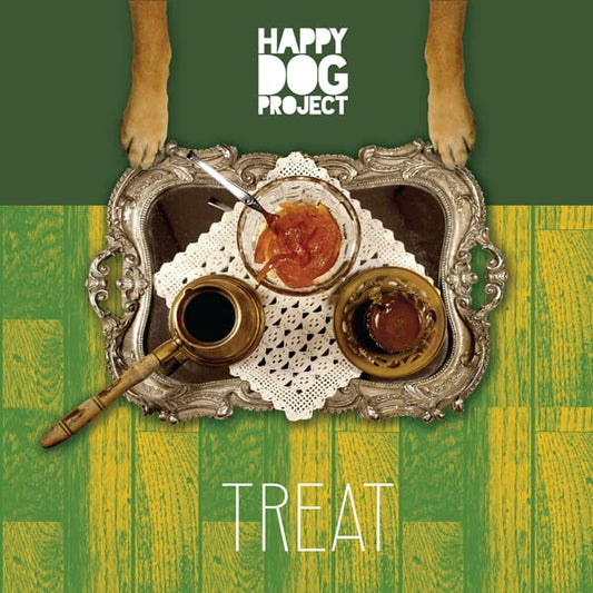 Dog paws above a silver tray with jam, coffee, and the word "TREAT".
