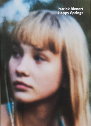 Close-up portrait of a young woman with blonde hair, soft focus.