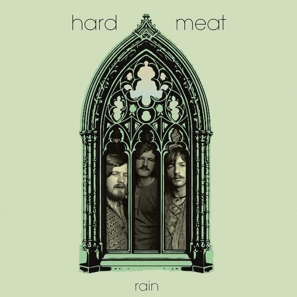 Album cover showing three men framed within a gothic arch on light green background.