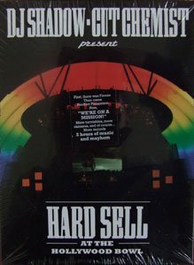 "Image shows DVD cover for 'Hard Sell' with rainbow-colored stage and dark background."