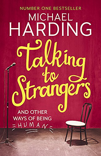 Red book cover with yellow title, microphone, and empty chair.