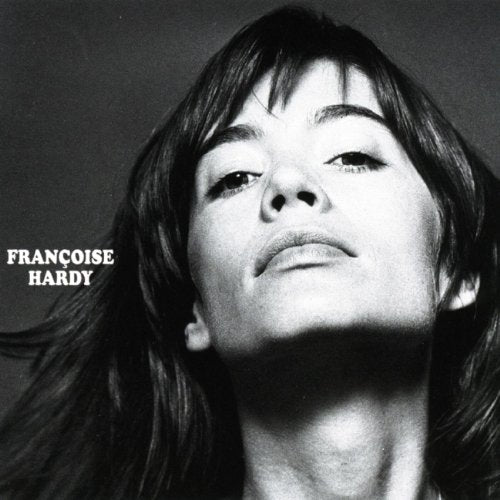 Black and white portrait of Françoise Hardy looking upward with her name on the left.