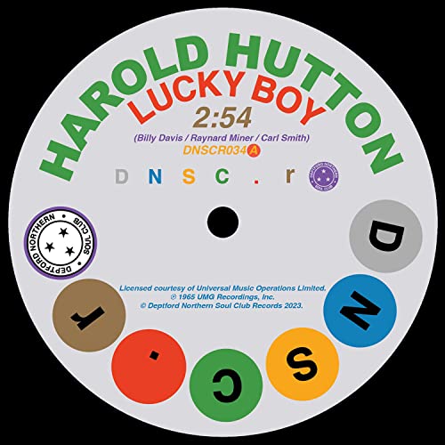White and green vinyl record label with text and colorful circles.