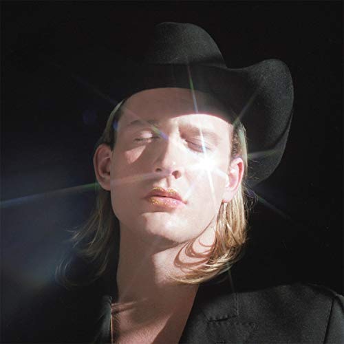 Person with blonde hair wearing a black cowboy hat, eyes closed.