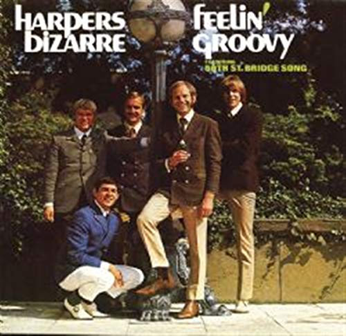 Five men in suits pose outdoors by a lamp post on a CD cover.