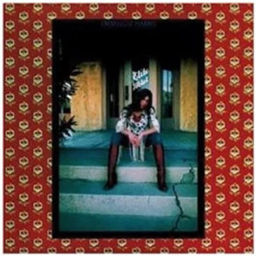 Album cover: Emmylou Harris seated outside a building, patterned border.