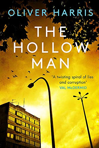 Book cover: “The Hollow Man” with a building, streetlights, and birds.