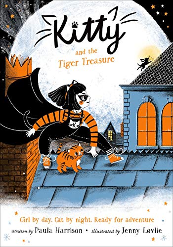 A girl in a cat costume and a small tiger kitten on a rooftop.