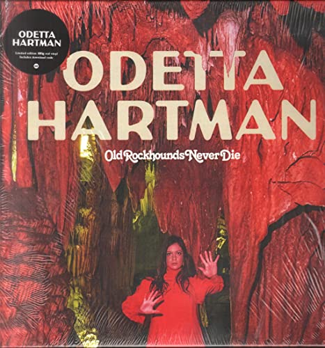 Odetta Hartman stands in a red-lit cave on this vinyl album cover.