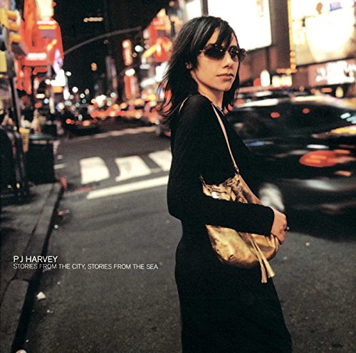 PJ Harvey album cover: woman in black dress facing city lights.