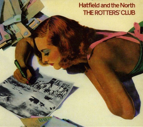 Album cover: woman in green dress lying on papers, holding pen, with red text above.