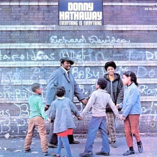 Donny Hathaway album cover: man with children in front of a brick wall.