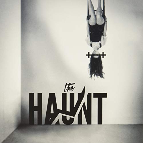 A person hangs upside down against a wall above the text The Haunt.