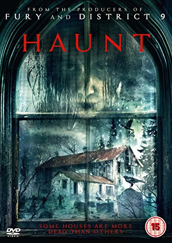 A ghostly face appears in a window overlooking a dark, snowy graveyard and house.
