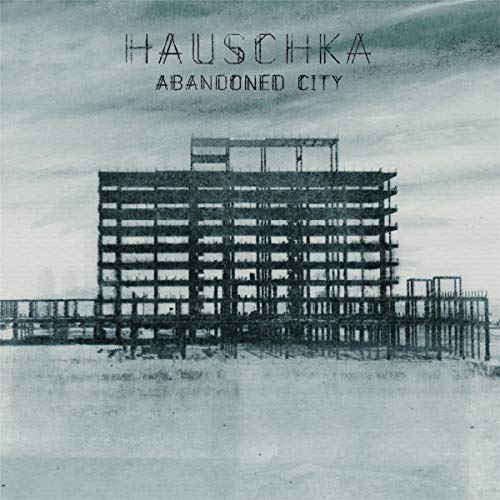 Hauschka “Abandoned City” CD cover: skeletal building in a hazy landscape.