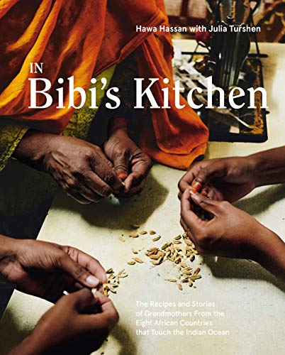 Cookbook cover featuring hands shelling spices, with the title “In Bibi’s Kitchen.”