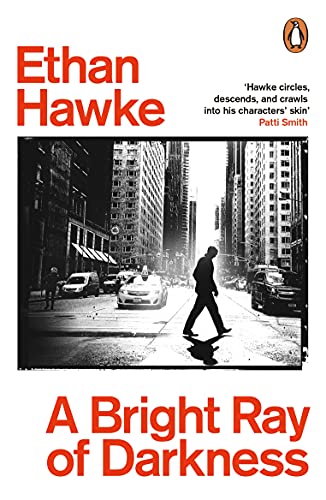 Book cover: man walking down a city street, black and white photo.