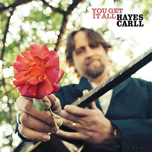 Hayes Carll album cover with a man holding a red rose and guitar.