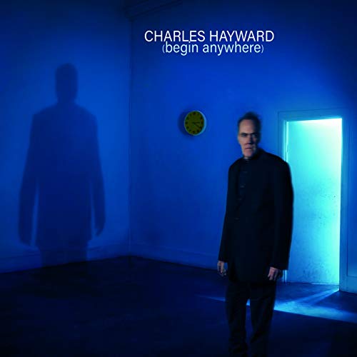 Album cover featuring a man in a dark room with a lit doorway behind him.