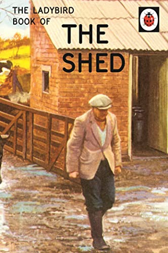 A man in a flat cap walks past a brick shed on a muddy path.