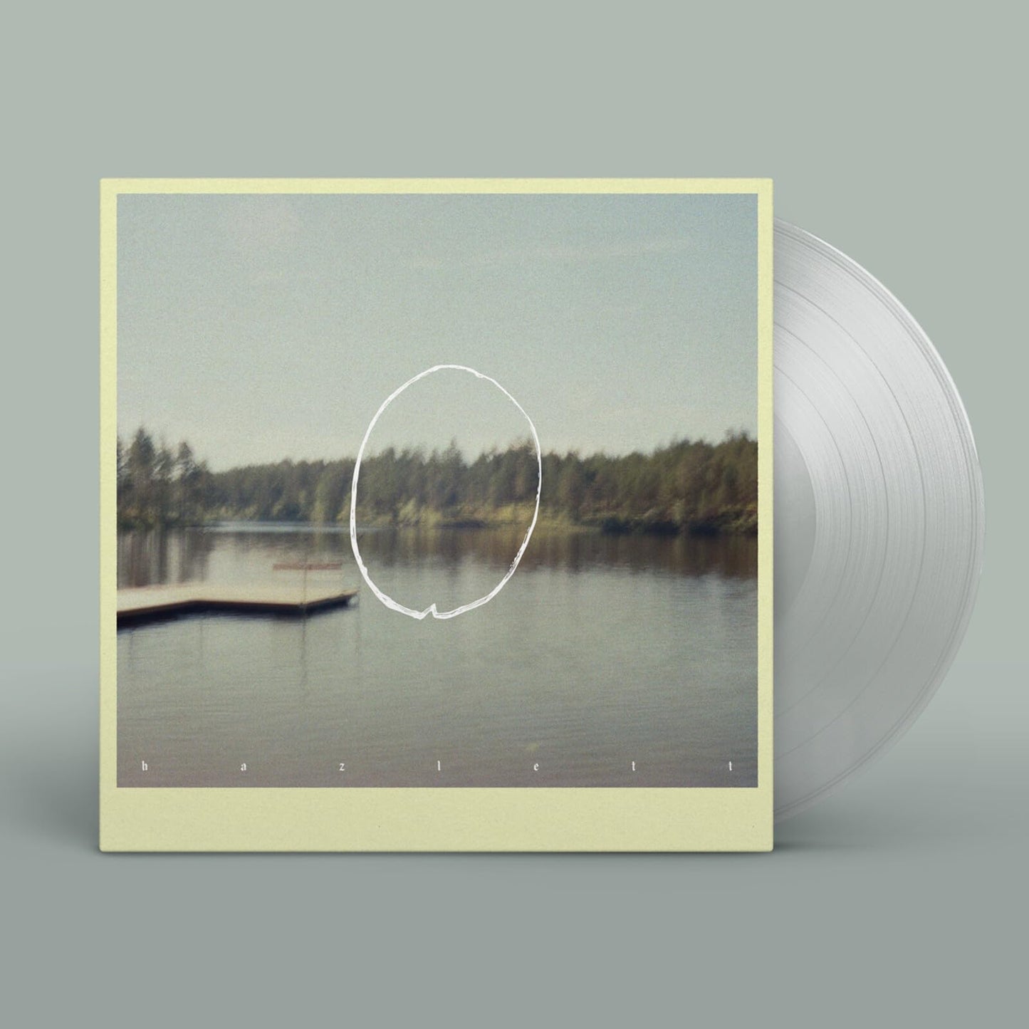 Vinyl record with cover art depicting a lake and forest scene.