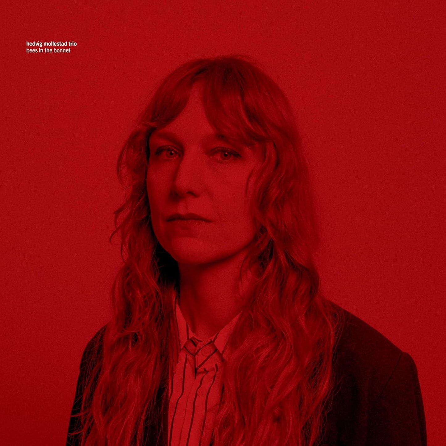 Red album cover featuring a portrait of a woman with long hair.