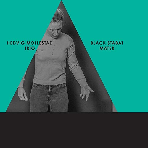 A black and white photo of a woman inside a teal triangle on black.