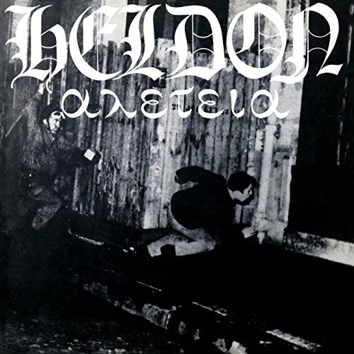 Black and white vinyl album cover with man sitting on steps, wearing a hat.