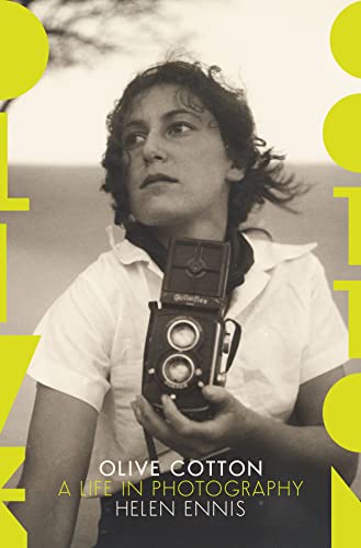 Vintage portrait of Olive Cotton holding a Rolleiflex camera.