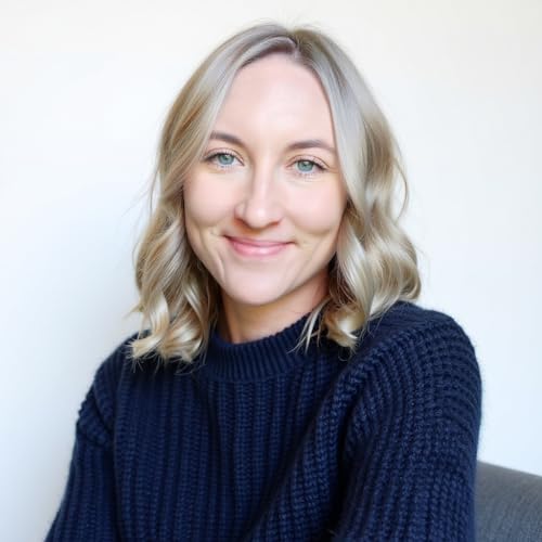 A smiling woman with shoulder-length blonde hair wearing a dark blue knitted sweater.