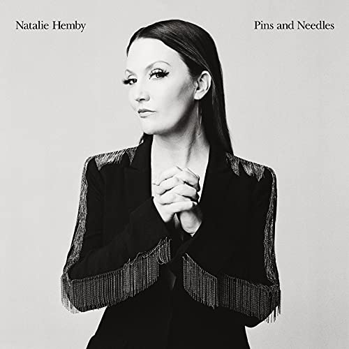 Black and white portrait of Natalie Hemby wearing a fringed blazer with hands clasped.