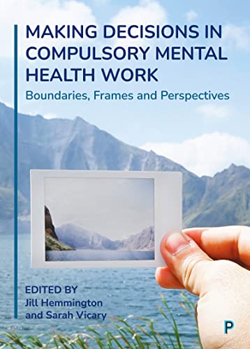 Book cover with a hand holding a photograph of mountains and water.