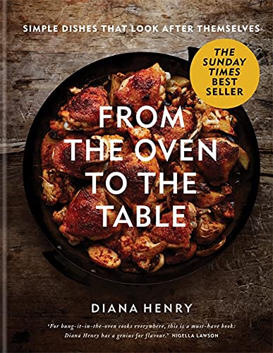 Cookbook cover featuring roasted chicken and vegetables in a black pan.