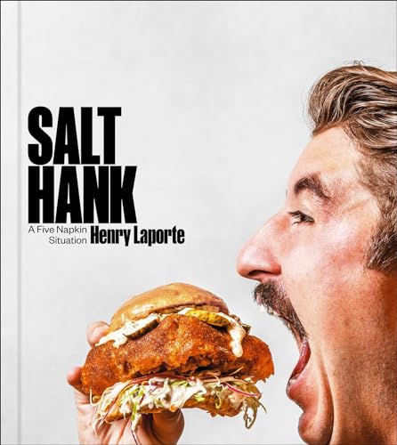 Cookbook cover featuring a man about to bite into a large fried chicken sandwich.