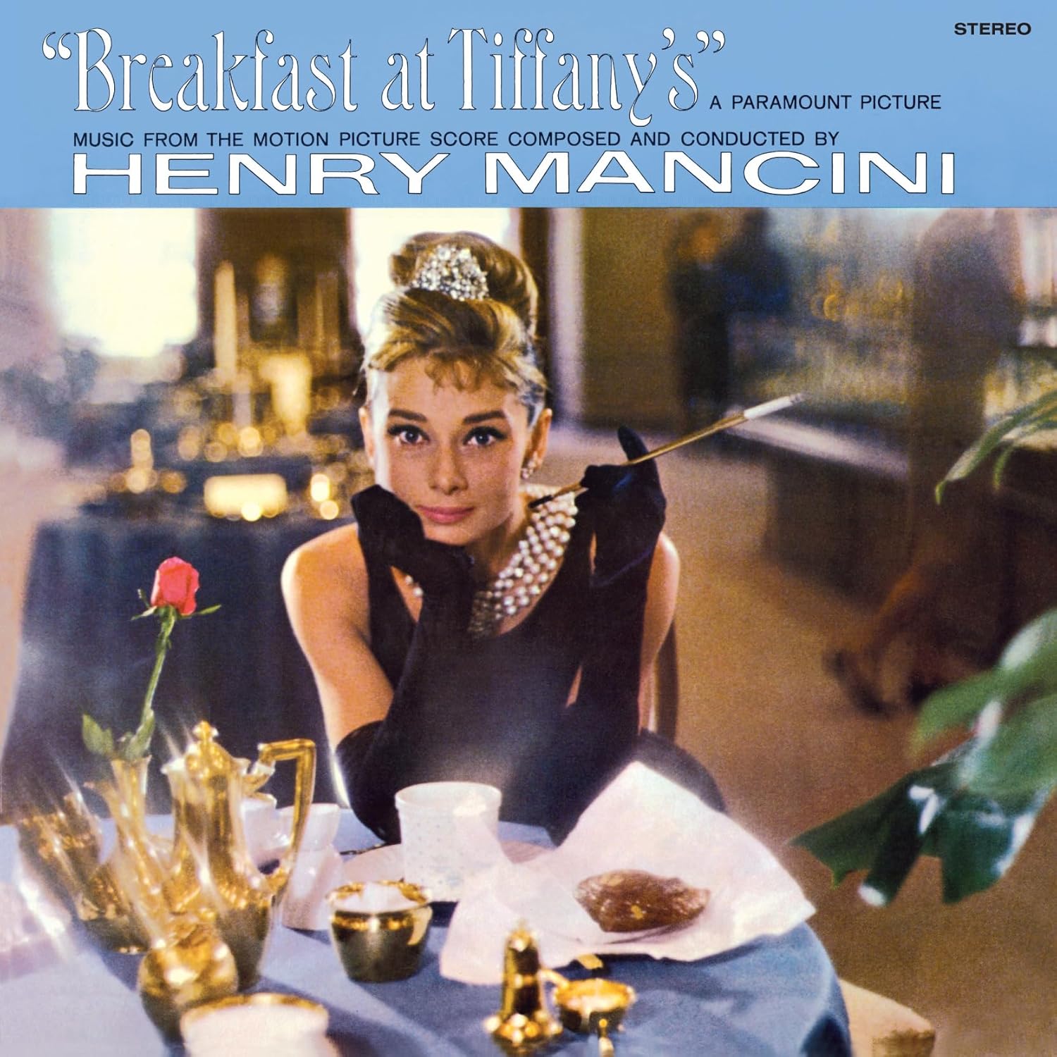 Audrey Hepburn on “Breakfast at Tiffany’s” vinyl record cover, pink and turquoise.