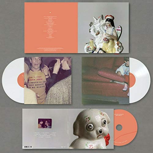 Vinyl record, album cover with statues, portraits, and a dog figurine.