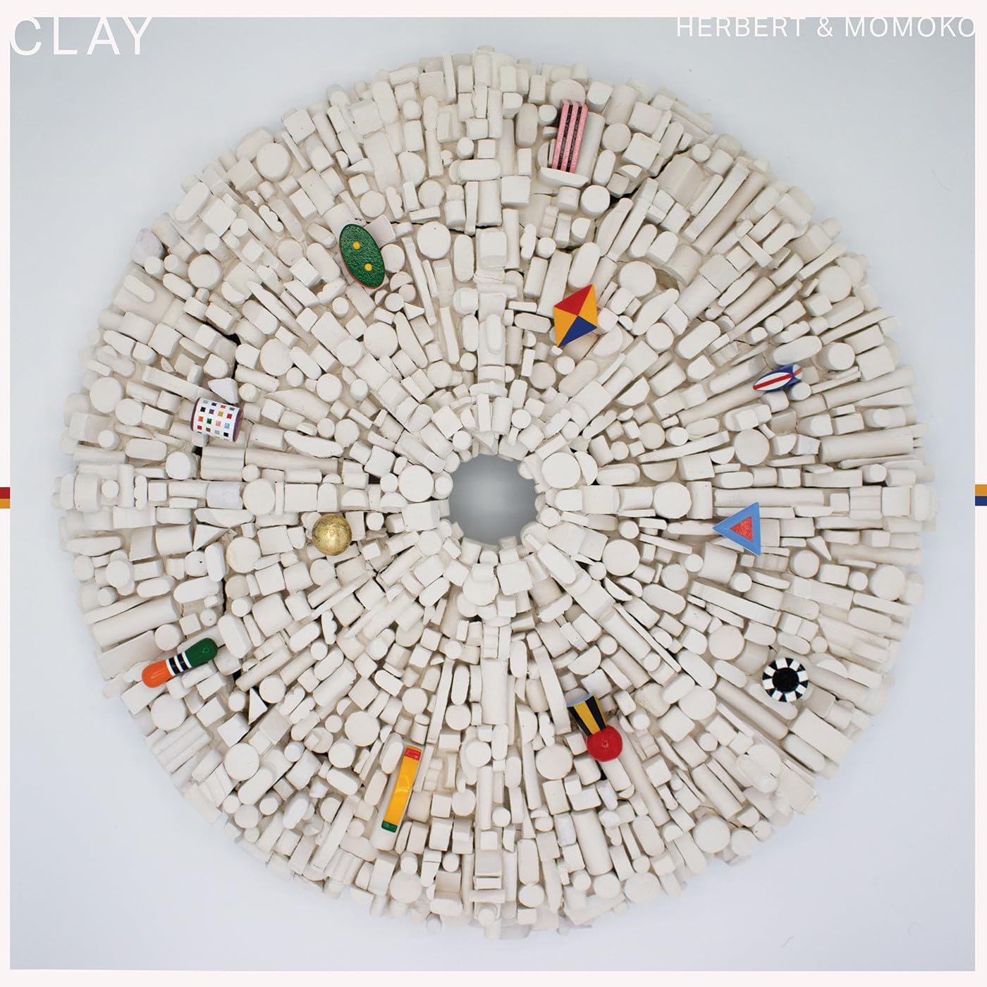 CD cover with a radial pattern of small white clay objects.