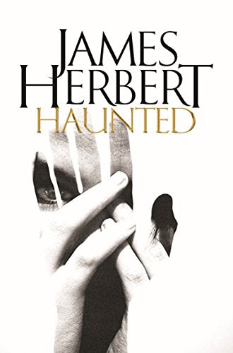 Book cover: "Haunted" by James Herbert, featuring a shadowy hand and eye.