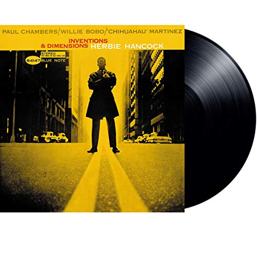 Herbie Hancock's "Inventions & Dimensions" vinyl record with a man in a suit.