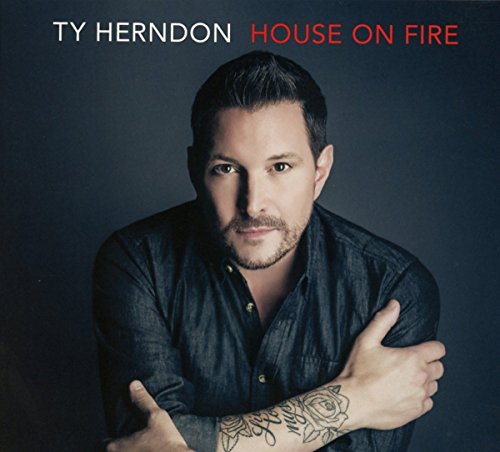 Ty Herndon album cover featuring a man with tattoos against a dark background.
