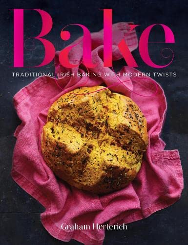 Cookbook cover featuring a rustic loaf of bread on pink fabric.