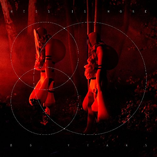 "Hanging marionettes in a dark forest, lit red, with white text and circles."