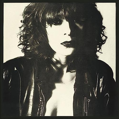 Black and white portrait of a person with curly hair, vinyl record.
