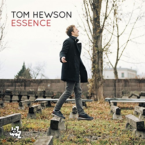 CD cover: Tom Hewson in a coat walking in a cemetery.