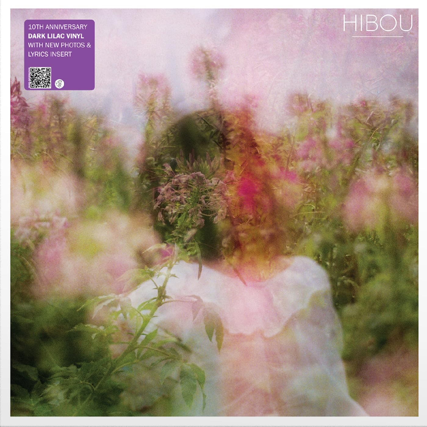 Vinyl album cover with a blurry, dreamy image of a person in flowers.