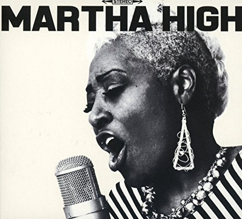 Black and white portrait of Martha High singing into a vintage microphone.